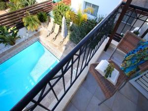 een balkon met uitzicht over het zwembad bij Villa Kos 19 in Protaras