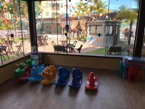 a group of childrens toys sitting on a floor in a room at Angra dos Reis - Porto Bali - SUÍTE no Porto Bali Resort in Angra dos Reis