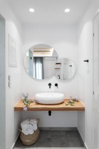 a bathroom with a sink and a mirror at Iades Studios & Apartments in Agia Anna Naxos