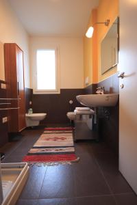 a bathroom with a sink and a toilet at La Lanterna in Padova
