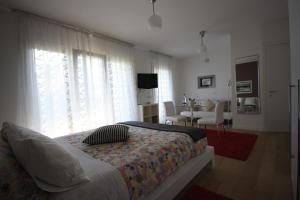 a bedroom with a bed and a living room at La Lanterna in Padova
