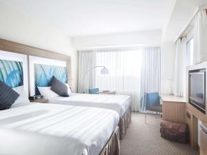 Postel nebo postele na pokoji v ubytování Novotel Tainui Hamilton