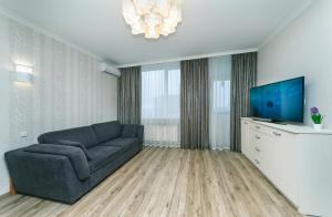 a living room with a couch and a flat screen tv at Квартира VIP класса рядом с Терминалом in Brovary