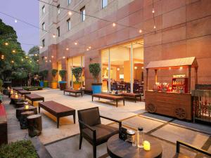 a patio with tables and chairs and a bar at ibis Pune Viman Nagar - An Accor Brand in Pune