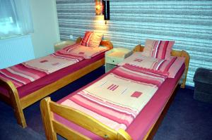 Postel nebo postele na pokoji v ubytování Flamingo Vendégház