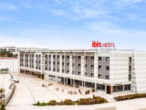a large building with a sign on the side of it at Ibis Madrid Alcobendas in Alcobendas