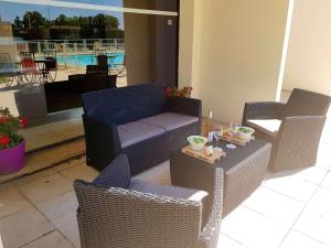 a patio with a couch and chairs and a table at ibis Budget Arles Palais Des Congres in Arles