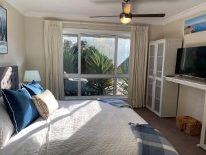 a bedroom with a large bed with a large window at Coastal Country Retreat, Spa, fireplace, pet friendly, FREE WIFI wine & chocolates, Kilarney, 10 minutes to Phillip Island in Kilcunda