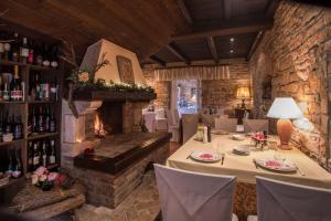 a dining room with a table and a fireplace at Boutique B&B Stancija 1904 Adults only in Svetvinčenat
