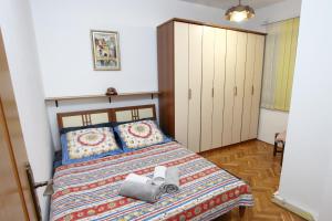 a small bedroom with a bed with a bed sqor at City Center Comfort Blue Sky in Koper