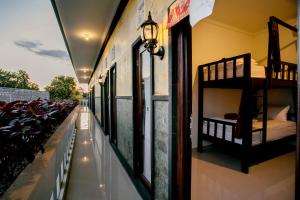 a room with two bunk beds on the wall at L Degus Hostel in Nusa Penida