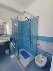 a bathroom with a shower and a toilet and a sink at Astra in Agerola