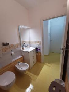 a bathroom with a toilet and a sink and a mirror at Astra in Agerola