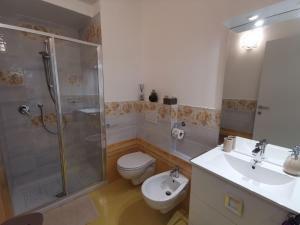 a bathroom with a shower and a toilet and a sink at Astra in Agerola