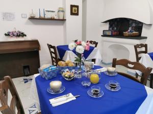 a table with a blue table cloth and flowers on it at Astra in Agerola