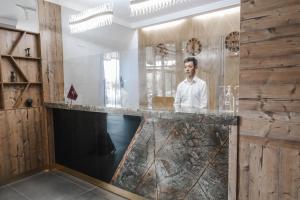 a man standing at a counter in a restaurant at INFINITY PLAZA BLOCK 1 in Atyraū