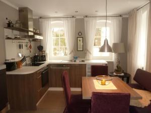 a kitchen with a table and a dining room at Apfeltraum-Erzgebirge in Neuhausen