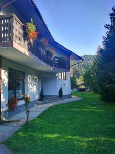 a house with flower boxes on the side of it at Pensiunea Raisa in Buşteni