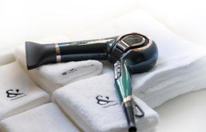 a hair dryer sitting on top of towels at ritomaru villa @ hatsuyama iki in Iki +24 photos