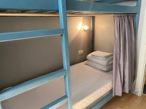a bunk bed in a room with a ladder at Hostel Umbrella in Tallinn