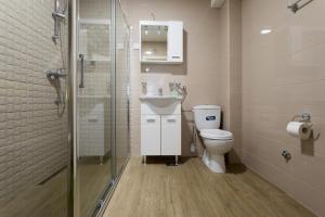 a bathroom with a toilet and a sink and a shower at Apartments Horizont in Budva