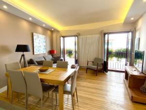 a living room with a dining room table and chairs at Apartamentos Turísticos Ezcaray in Ezcaray