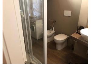 two pictures of a bathroom with a toilet and a sink at Casa Loro in Bergamo