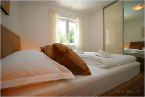 Postel nebo postele na pokoji v ubytování Apartments Nika + 37 fotografií