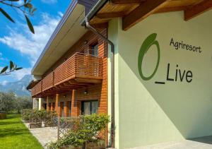 een gebouw met een bord aan de zijkant bij O_live Agriresort in Arco