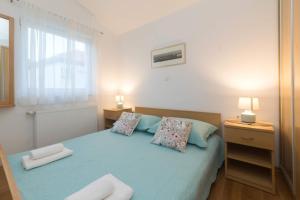 Postel nebo postele na pokoji v ubytování Apartmani Lenka
