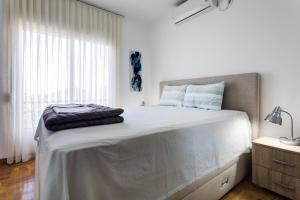 a bedroom with a large bed with a large window at Apartments Horizont in Budva