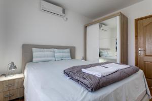 a bedroom with a bed with two towels on it at Apartments Horizont in Budva