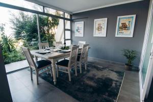 a dining room with a table and chairs at 9 Kyalanga Beach in Durban