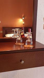 a table with several glass dishes on it in front of a mirror at House Chrysoula Mitsokopi in Sarti