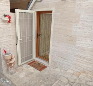an open door to a house with a patio at La ramasola & il datterino in Pezze di Greco +104 photos