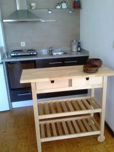 a kitchen counter with a sink and a stove at Studio Downtown Oporto in Porto