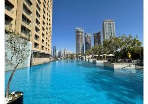 a large swimming pool in the middle of a city at Dubai Mall Residences -Luxury 1 bedroom in Dubai