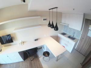 an overhead view of a kitchen with white cabinets and a counter at Student Park 636 by We Stay in Yogyakarta