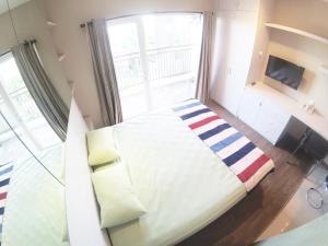 a small bedroom with a bed with a window at Student Park 636 by We Stay in Yogyakarta