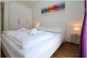 Postel nebo postele na pokoji v ubytování Apartments Nika
