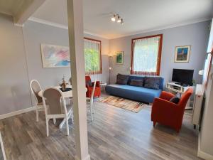 a living room with a blue couch and a table at Holiday House Filemon in Vonyarcvashegy
