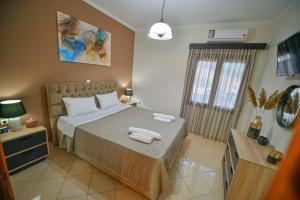 a bedroom with a bed with towels on it at Gardenia Apartment in Kissamos