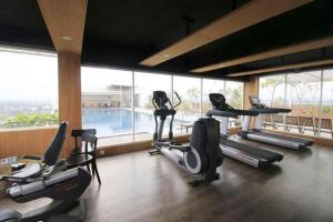 a gym with a bunch of exercise bikes in a room at Student Park 636 by We Stay in Yogyakarta
