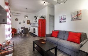 een woonkamer met een bank en een rode koelkast bij Your Apartment Catania in Catania