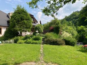 a garden in front of a house at Penzion Beskyd in Dolní Bečva