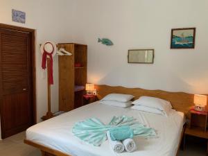 a bedroom with a bed with towels on it at Del & Sol in Skopelos Town