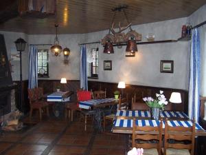 a dining room with tables and chairs in a room at Wiatrak Nowe Guty in Nowe Guty