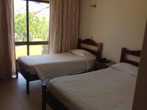 Postel nebo postele na pokoji v ubytování Ribeiro Hotel
