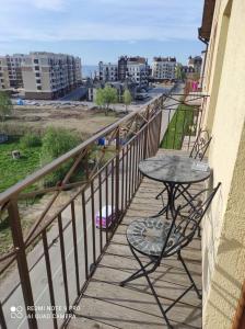 a table and chairs on a balcony with a view at ЖК Прибалтийский силуэт in Zelenogradsk