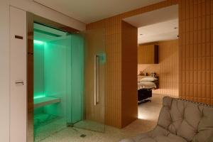 a glass door in a room with a bed at Zlata Ladjica Boutique Hotel in Ljubljana
